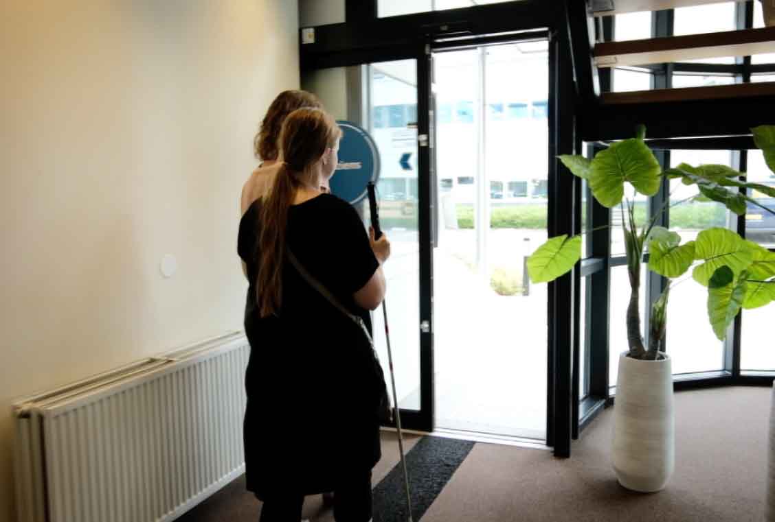 image of blind person being led by researcher